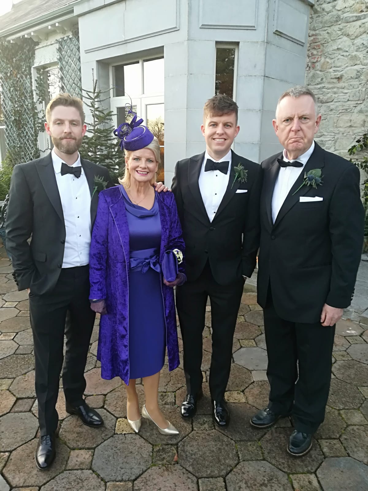 family with suits with a lady in a coat